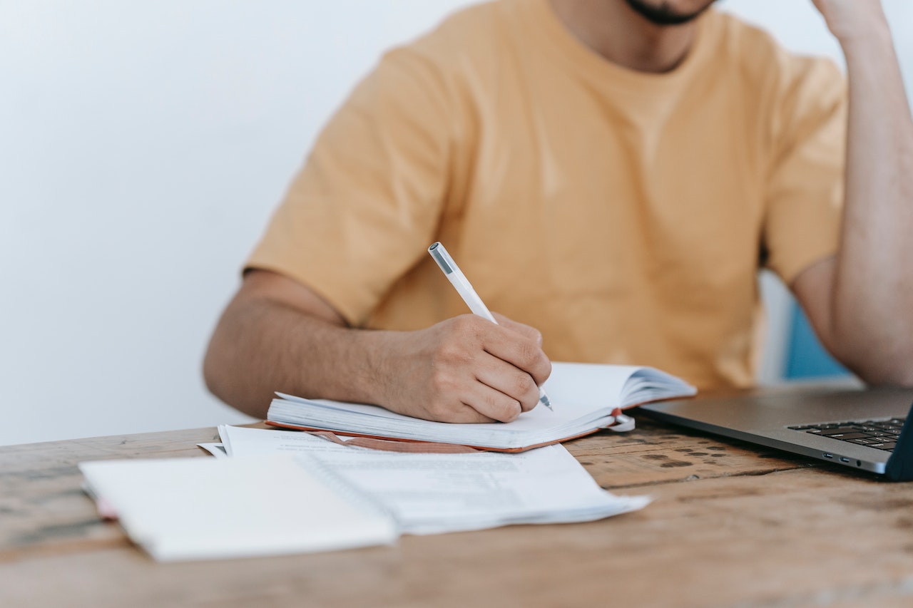 A man sitting at a desk with papers and a computer